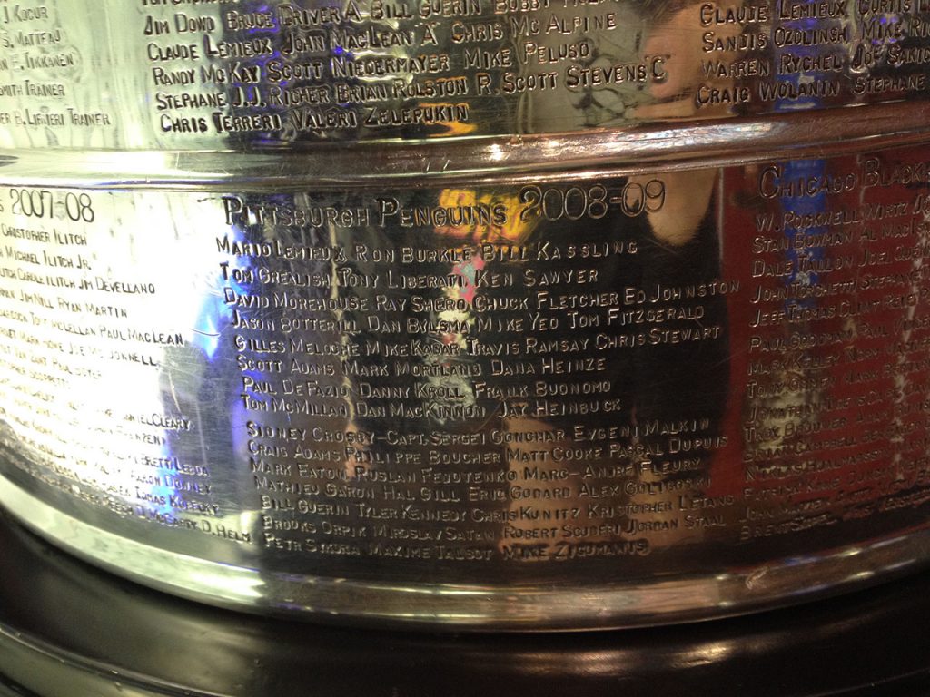 Close-up of the engraved names on the Stanley Cup.