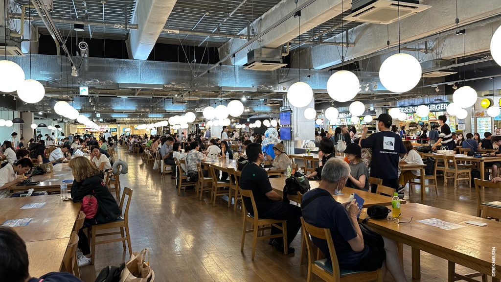 The food court at Narita Terminal 3, showing hundreds of seats and a wide variety of (Japanese) food options. And one burger joint.