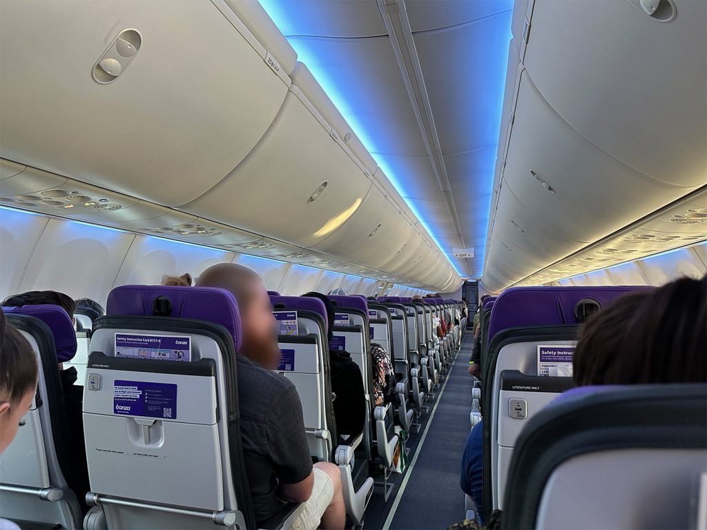 The cabin of Bonza's Boeing 737 MAX 8 fleet, showing six seats per row, 3 on each side of the aisle.