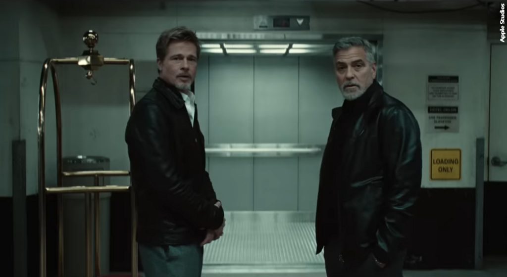 Brad Pitt and George Clooney ponder their situation in "Wolfs" (2024).